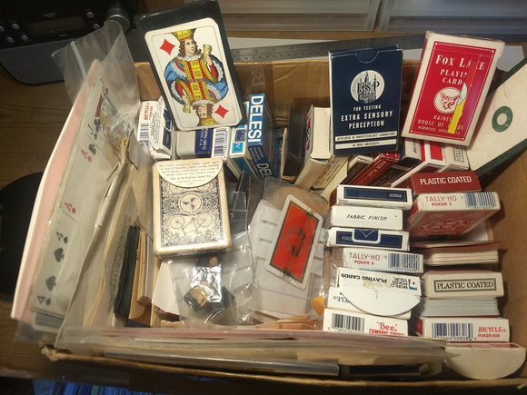 Box of mixed packs of magical playing cards and ephemera
